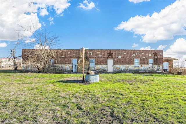 back of property featuring a yard