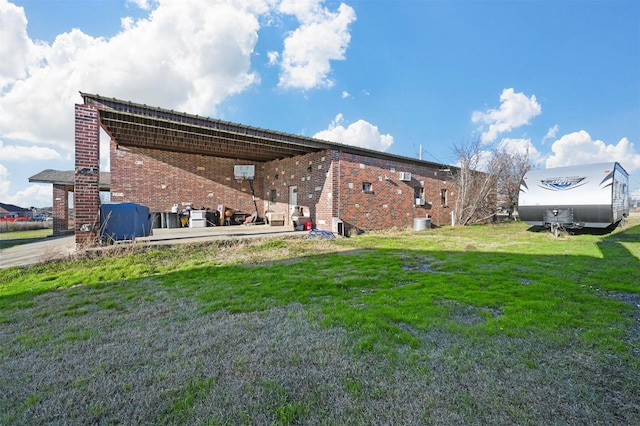 rear view of property featuring a yard