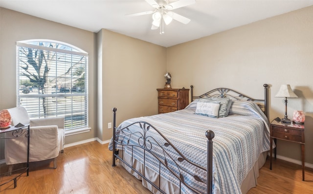 bedroom with ceiling fan and hardwood / wood-style floors