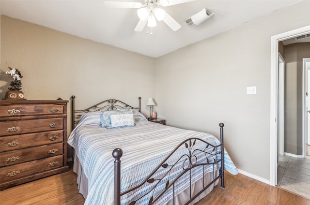 bedroom with wood-type flooring and ceiling fan