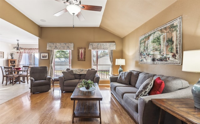 living room featuring lofted ceiling, wood-type flooring, and ceiling fan