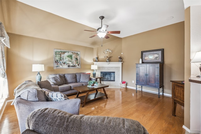 living room featuring a fireplace, ceiling fan, and hardwood / wood-style flooring