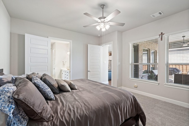 carpeted bedroom featuring ensuite bath and ceiling fan