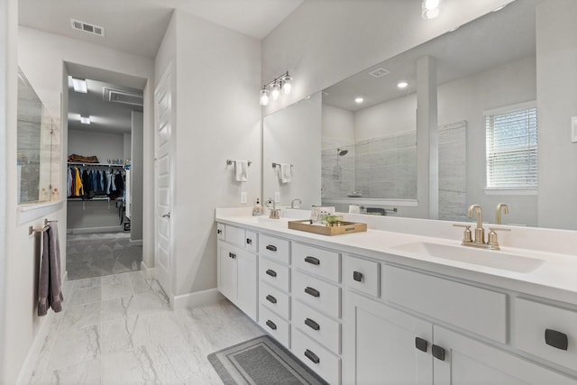 bathroom featuring walk in shower and vanity