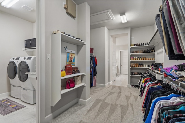 walk in closet featuring independent washer and dryer and light carpet