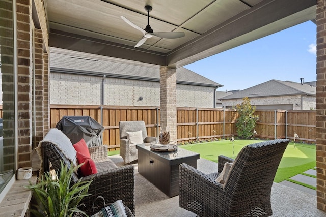 view of patio with area for grilling, ceiling fan, and an outdoor living space