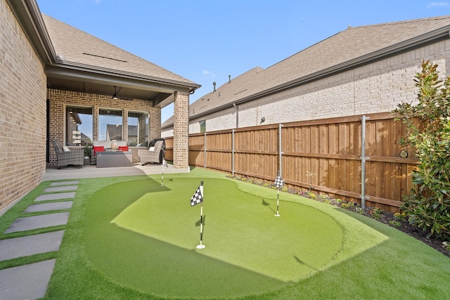 view of yard with ceiling fan and a patio area