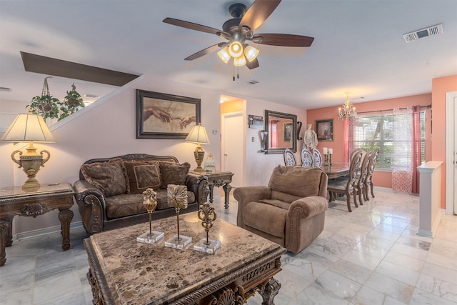 living room with ceiling fan with notable chandelier