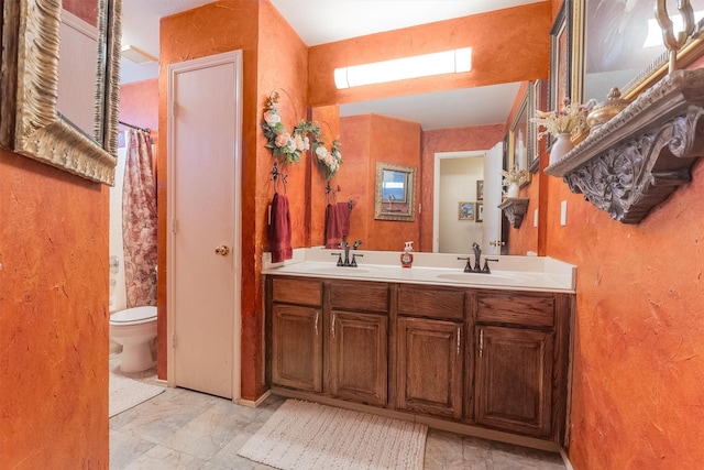 bathroom featuring toilet and vanity