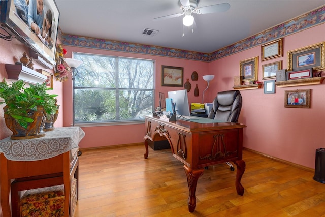 office with ceiling fan and light hardwood / wood-style flooring