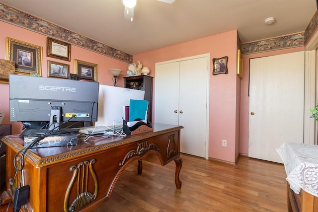 home office featuring ceiling fan and light hardwood / wood-style flooring