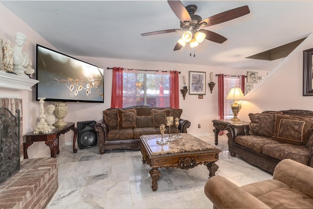 living room featuring ceiling fan and a fireplace