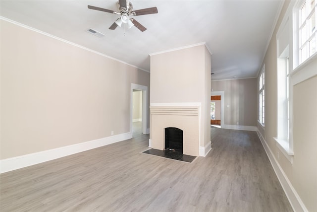 unfurnished living room featuring ornamental molding, ceiling fan, and light wood-type flooring