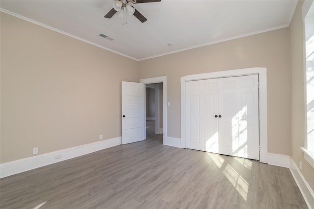 unfurnished bedroom featuring ceiling fan, light hardwood / wood-style flooring, and crown molding