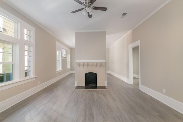 unfurnished living room with ceiling fan, crown molding, and wood-type flooring