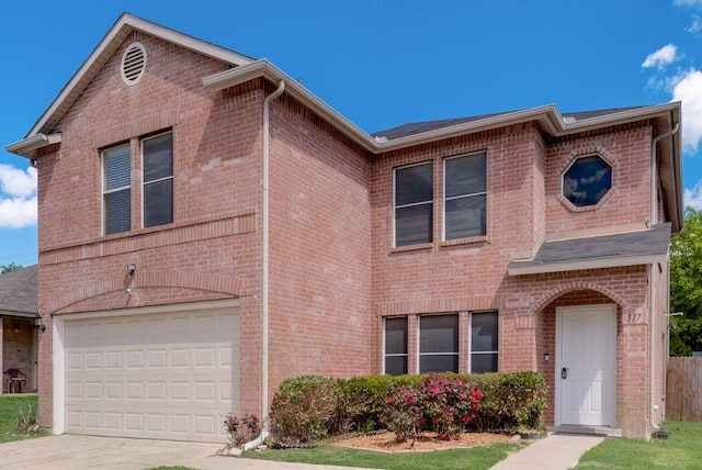 traditional-style house featuring concrete driveway, brick siding, and a garage