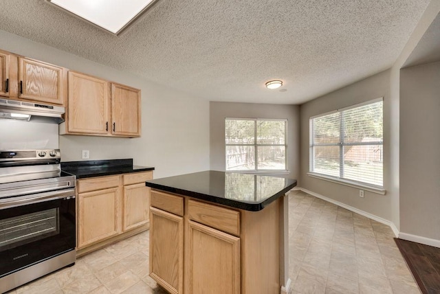 kitchen featuring stainless steel electric stove, a kitchen island, a textured ceiling, and light brown cabinetry