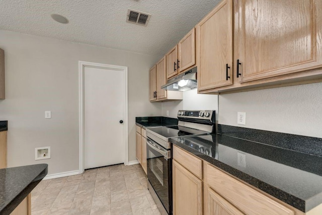 kitchen featuring dark stone counters, stainless steel electric range oven, a textured ceiling, and light brown cabinets