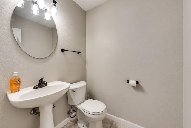 bathroom with tile patterned floors and toilet