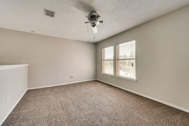 carpeted empty room featuring a textured ceiling and ceiling fan