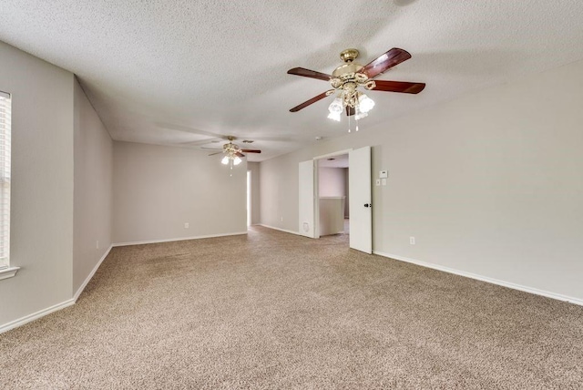 unfurnished room with a textured ceiling, ceiling fan, and carpet floors