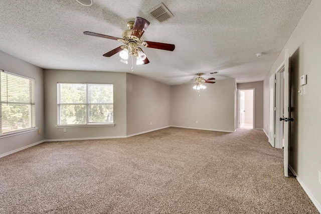 carpeted empty room with a textured ceiling and ceiling fan