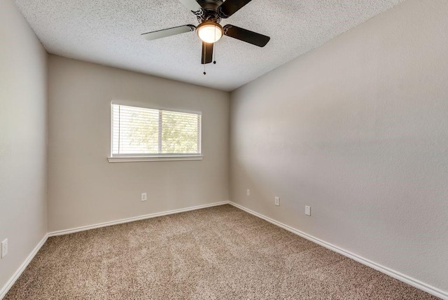 empty room featuring carpet floors, ceiling fan, and a textured ceiling