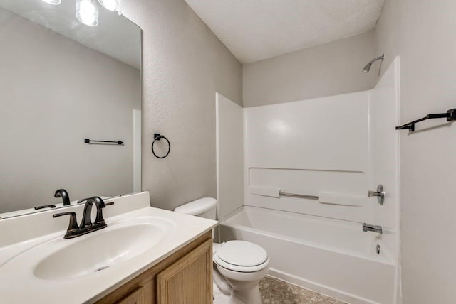 full bathroom with toilet, vanity, a textured ceiling, and bathtub / shower combination