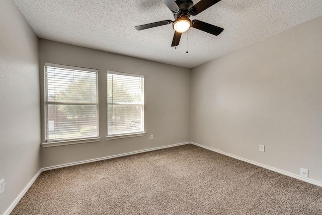 carpeted empty room featuring a textured ceiling and ceiling fan