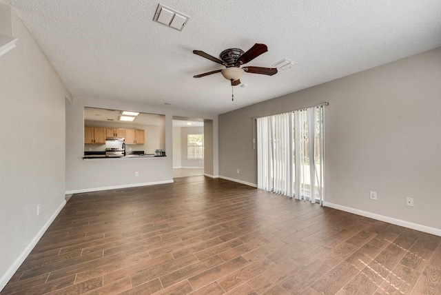 unfurnished living room featuring a textured ceiling, ceiling fan, and dark hardwood / wood-style floors