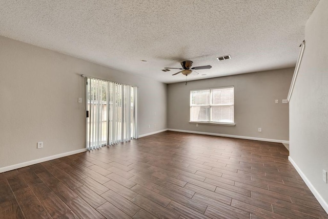 unfurnished room featuring ceiling fan, a wealth of natural light, and a textured ceiling