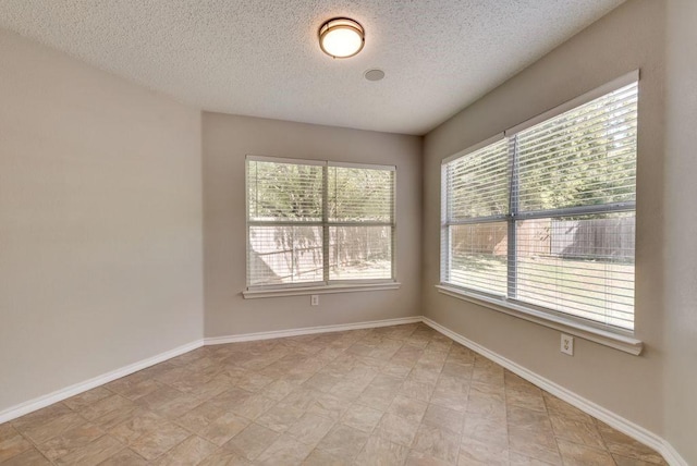 spare room featuring a textured ceiling