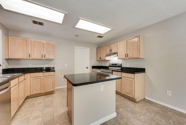 kitchen featuring sink, a kitchen island, light brown cabinetry, and appliances with stainless steel finishes