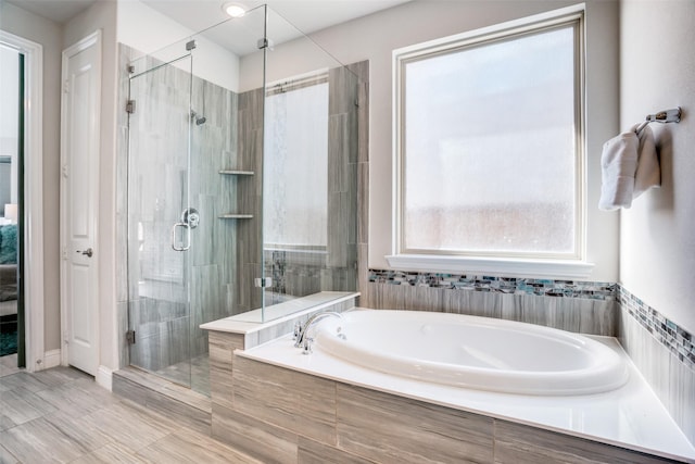 bathroom with a garden tub and a stall shower