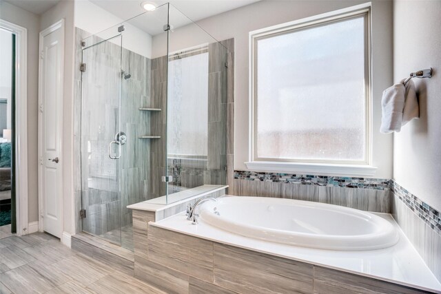 bathroom featuring a bath and a stall shower