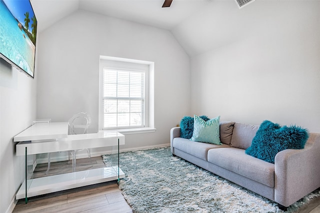 living room featuring ceiling fan, baseboards, lofted ceiling, and wood finished floors