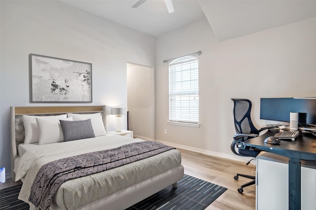 bedroom featuring ceiling fan, baseboards, and wood finished floors