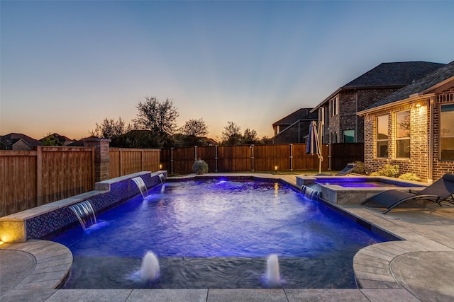 view of pool featuring an in ground hot tub, a fenced backyard, a fenced in pool, and a patio area