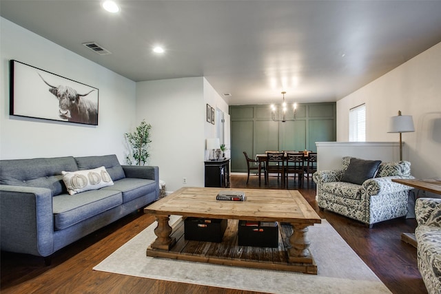 living room featuring dark hardwood / wood-style flooring and a chandelier