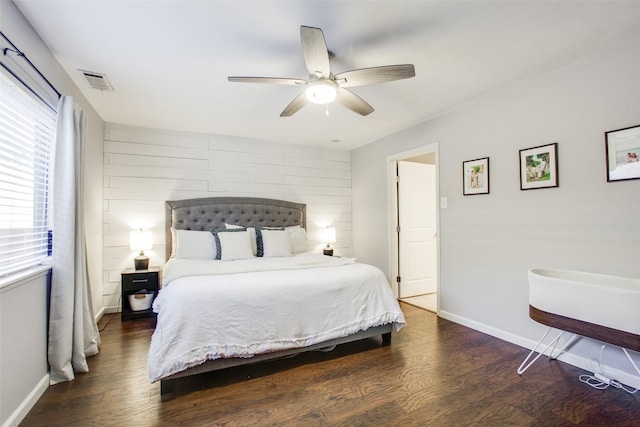 bedroom with dark hardwood / wood-style flooring and ceiling fan