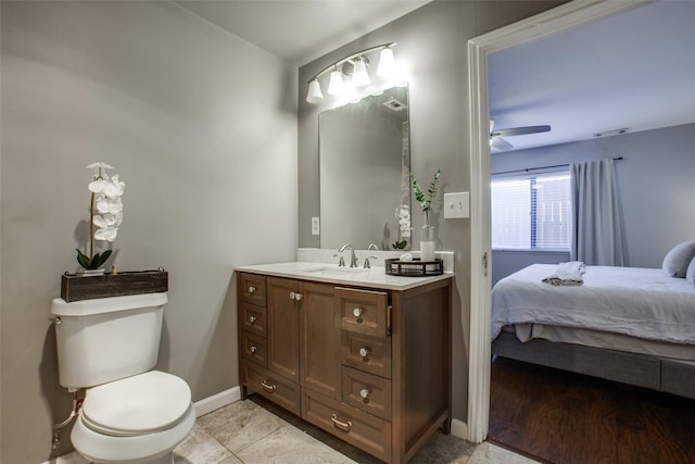 bathroom with toilet, tile patterned flooring, ceiling fan, and vanity