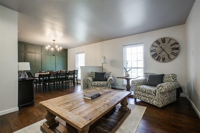 living room featuring dark hardwood / wood-style flooring and a notable chandelier