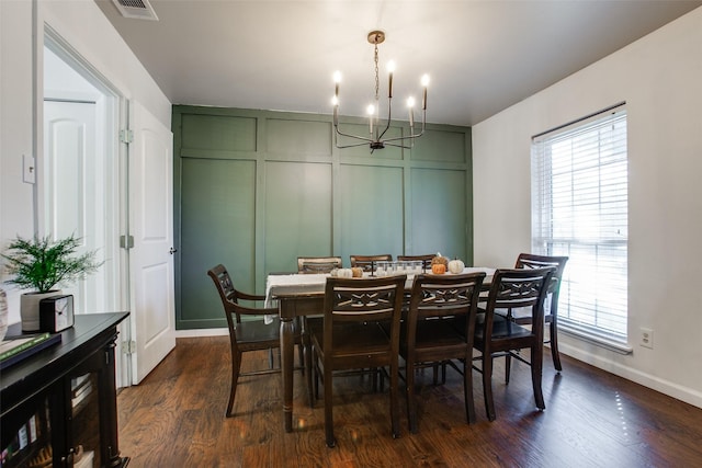 dining room with dark hardwood / wood-style flooring, a chandelier, and a healthy amount of sunlight