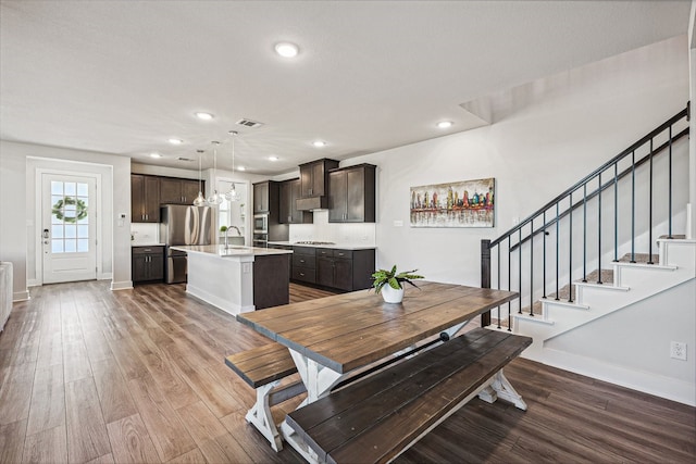 dining room featuring hardwood / wood-style flooring and sink