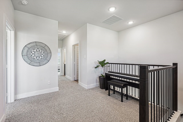 corridor with light colored carpet