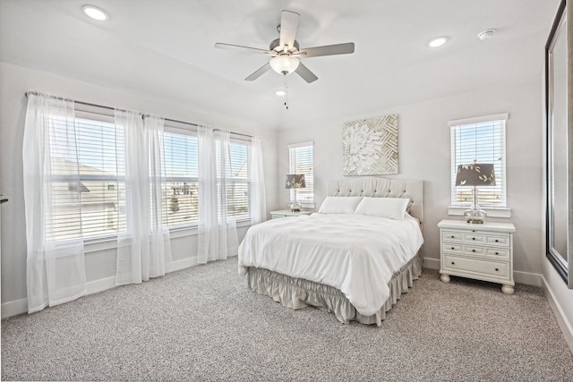 bedroom featuring multiple windows, ceiling fan, and carpet