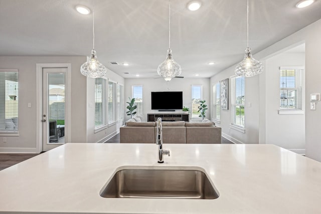 kitchen featuring sink, decorative light fixtures, and plenty of natural light