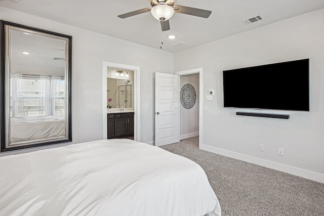 bedroom featuring ensuite bathroom, ceiling fan, and light colored carpet