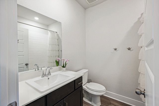 bathroom with a shower with shower curtain, toilet, vanity, and wood-type flooring