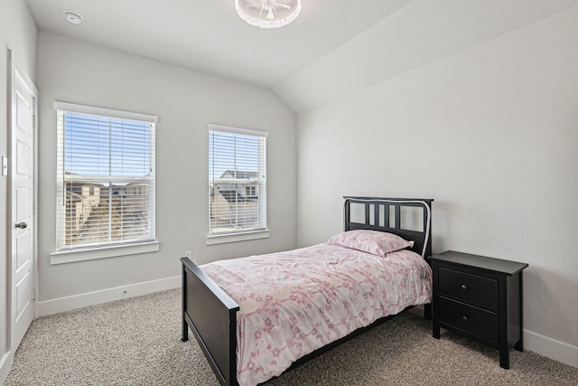 bedroom with light colored carpet and vaulted ceiling